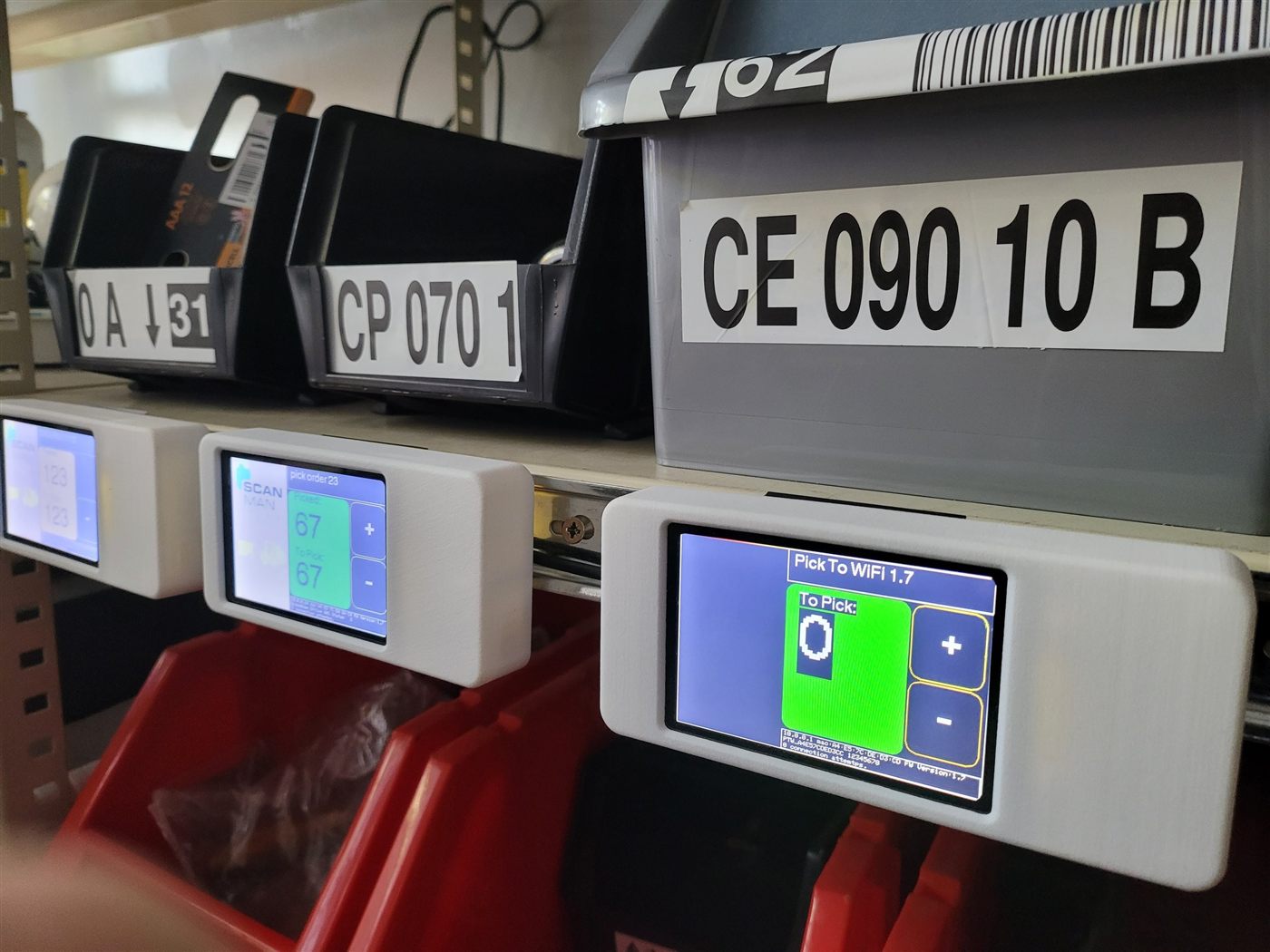 Pick To WiFi devices clipped onto shelf-edge racking next to bin locations, mid pick run